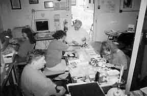 Figure 8.14 Fort Guijarros Museum Foundation laboratory in Building 127, Fort Rosecrans Historic District, Naval Base Point Loma. Featured in the photo are Dale Ballou May at the computer, Ron May near the door, Susan Floyd to his left, Heather Haisten to his right, and G. Scott Anderson at the bottom of the photo. 