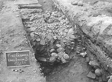 Figure 8.19 This exposure of the architectural ruin shows the fort wall tiles collapsed down the cobblestone ramp that buttressed the outside wall of the fort. Fort Guijarros Museum Foundation Photo Collection, P:81-332.