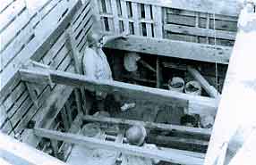 Figure 8.29 This view shows the heavy shoring necessary to create a safe working environment deep below the 20th-century fill that covers the mid-19th-century to late 18th-century trash deposits behind the walls of Fort Guijarros in Field IV. Fort Guijarros Museum Foundation Photo Collection, P:84-636